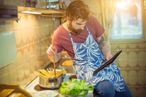 istock Handsome bearded young man making healthy meal 652500474