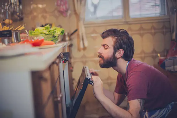 Beautiful young man preparing healthy meal