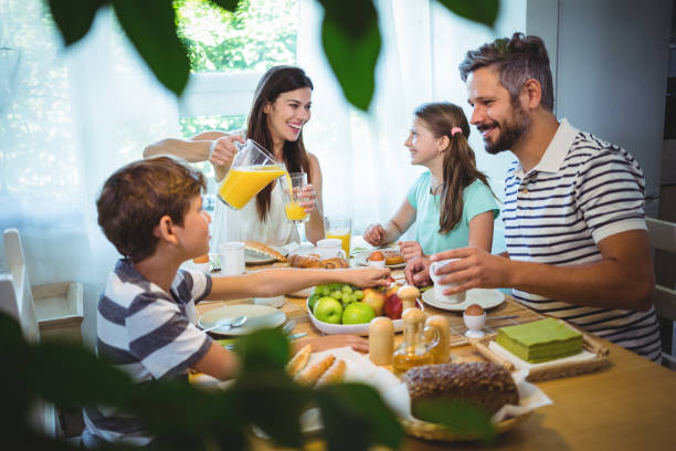 istock Happy family talking to each other while having breakfast together 652506440
