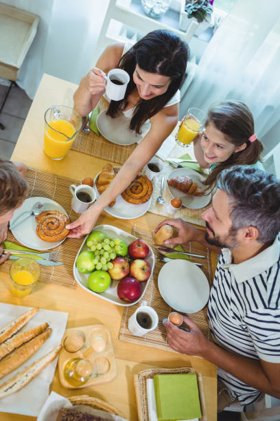 istock Happy family having breakfast at home 652506636