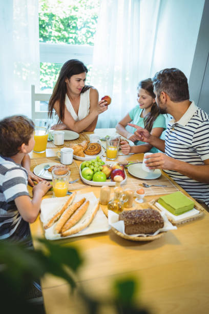 istock Happy family talking to each other while having breakfast together 652506790