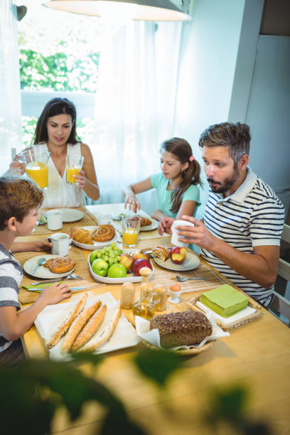istock Happy family talking to each other while having breakfast together 652506812
