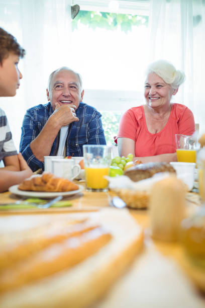 istock Boy and grandparents sitting at breakfast table 652507200
