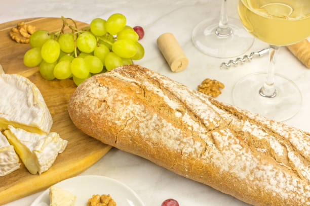 istock Loaf of white bread with cheese, grapes, and wine 652516796