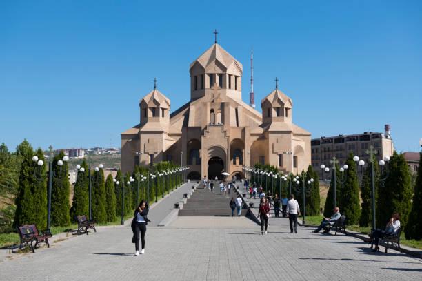 People walk outside Saint Gregory the Illuminator Cathedral in Yerevan, Armenia