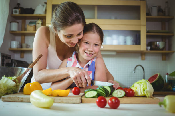 istock Mother and daughter preparing salad 652520914