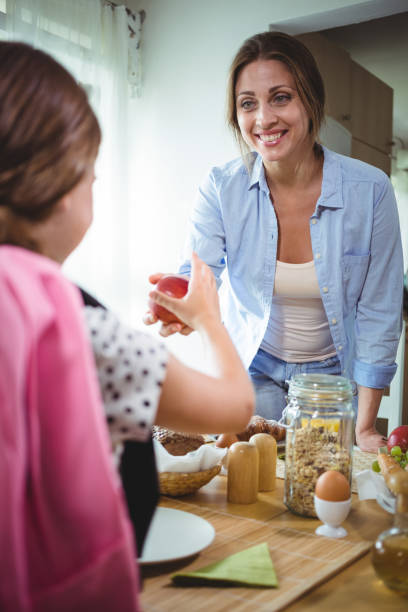 istock Mother giving apple to her daughter 652529630
