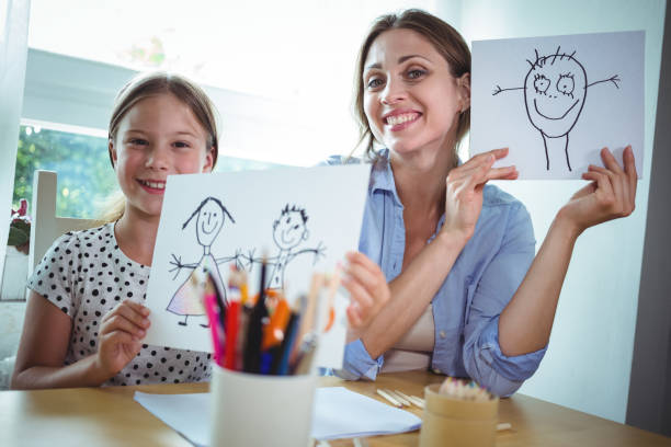istock Mother and daughter showing their drawings 652529910