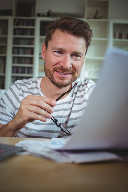 istock Happy man looking at his bills 652530152