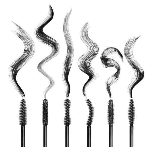 Set of various mascara brushes with mascara strokes isolated on white background