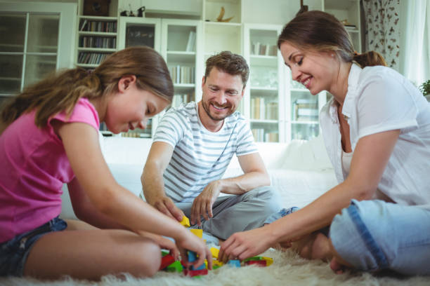 istock Parents and daughter playing with building blocks 652535538