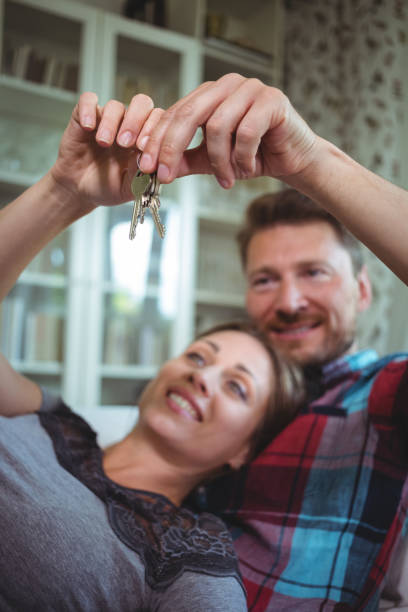 istock Happy couple holding their house key 652535826