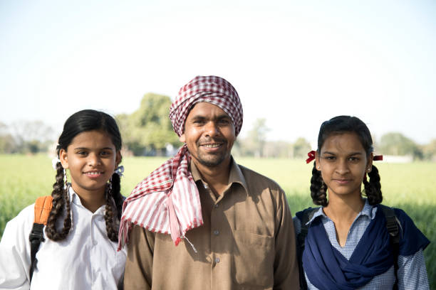 istock Indian farmer with daughters in school uniform 652546272