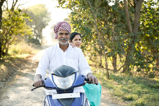 istock Indian farmer with wife riding motorcycle 652546668