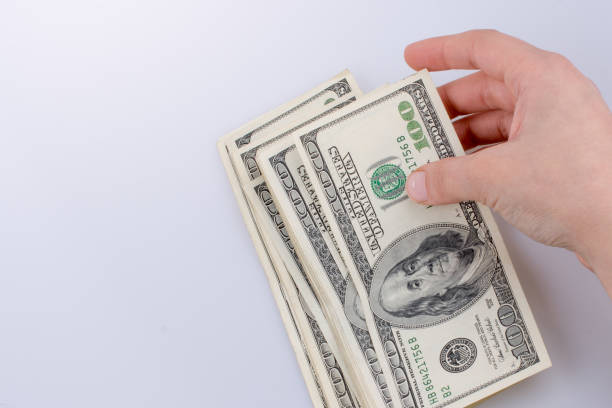 istock Human hand holding American dollar banknotes on white background 652549262