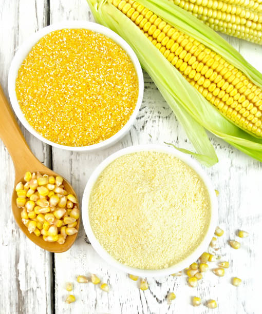 istock Flour and grits corn in bowls with grains on board top 652549882