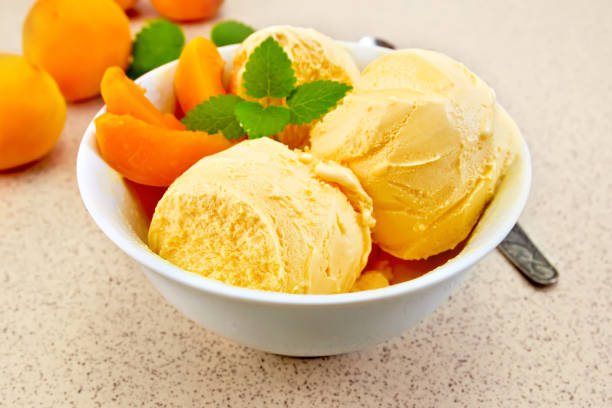 istock Ice cream apricot in white bowl on table 652553072