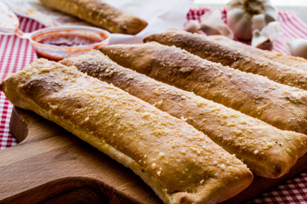 istock Garlic bread sticks with tomato sauce and parmesan cheese. 652563360