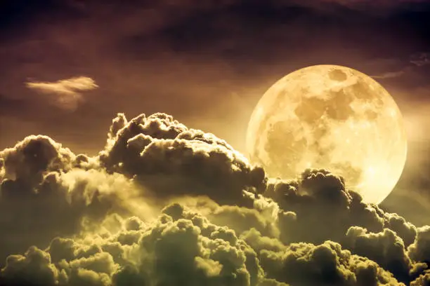 Photo of Sky with clouds and full moon with shiny. Sepia tone.