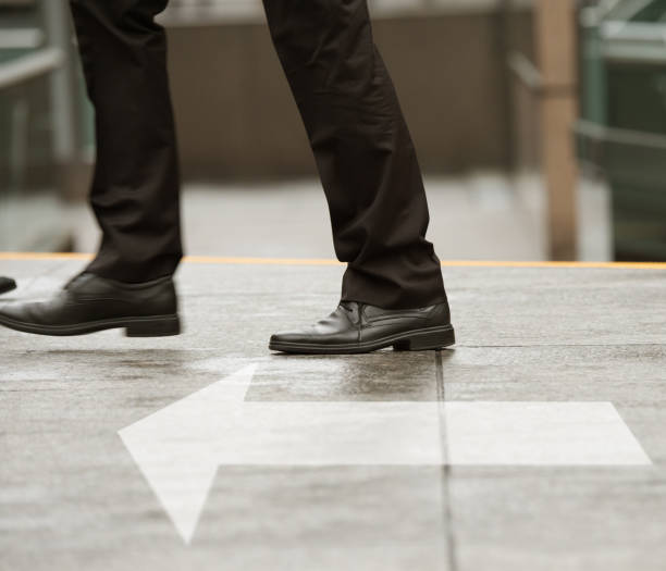 istock Man moving forward, arrow on street 652564808