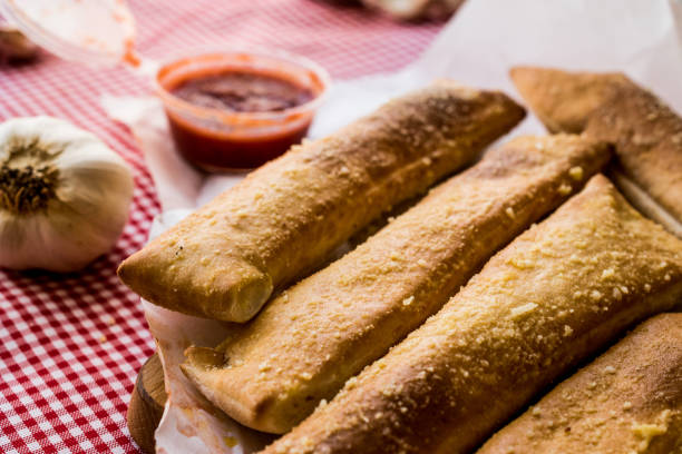 istock Garlic bread sticks with tomato sauce and parmesan cheese. 652564998