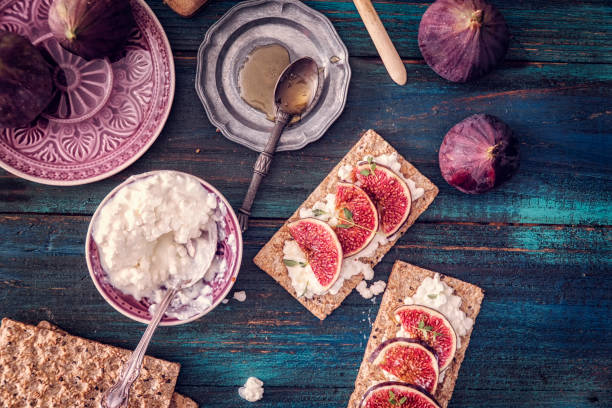 Crispbread with Serrano Ham, Cottage Cheese, and Figs Crispbread with Serrano Ham, Cottage Cheese, and Figs Served on a Table cottage cheese photos stock pictures, royalty-free photos & images