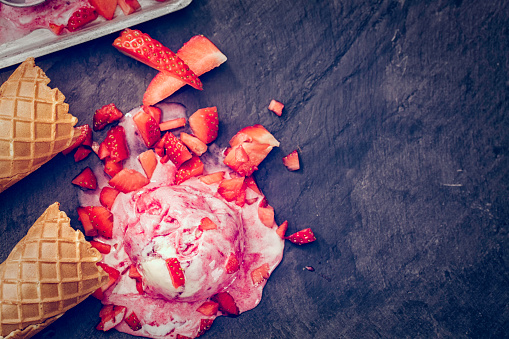 Homemade strawberry ice cream with fresh strawberries. This creamy delicious ice cream is a perfect treat on a sunny day.