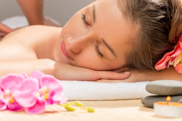 istock brunette with closed eyes relaxes during a back massage at the spa 652572928