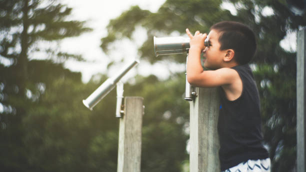 patrząc przez lornetkę. - little boys discovery binoculars child zdjęcia i obrazy z banku zdjęć