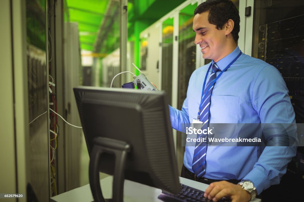 Technician Using Digital Cable Analyzer While Working On Personal ...