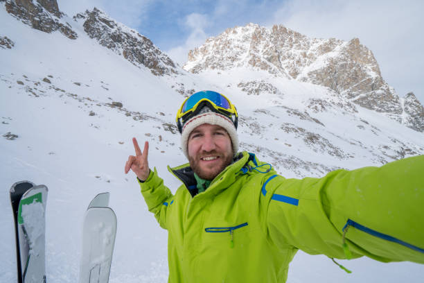 istock Young man taking selfie in ski slope, Switzerland 652580624