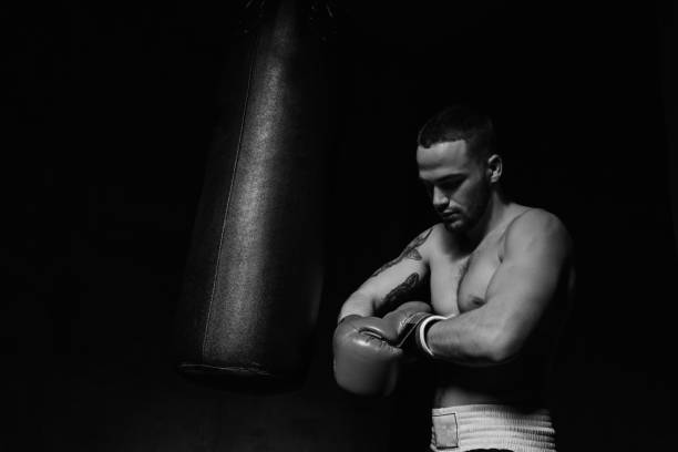 istock Boxer man putting on boxing gloves 652584974