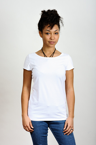 A young woman wearing a white T-shirt in front of a white background