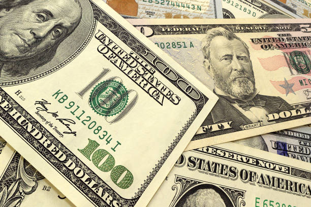 istock Abstract dollar bills of different denominations background. 652595544