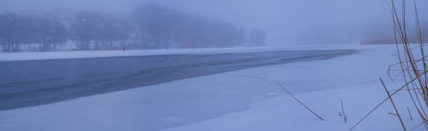 istock Winter river in foggy morning 652598236
