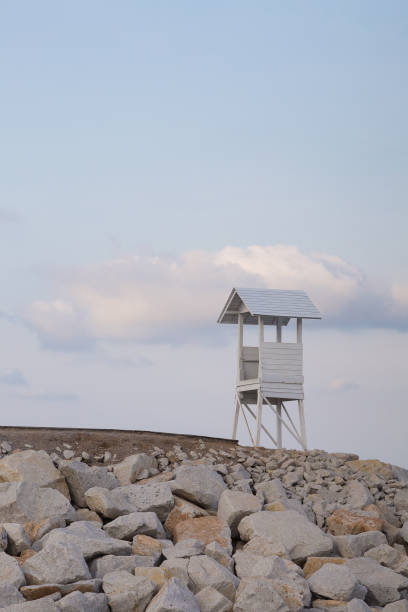 istock Lifeguard stand over rocky coastline 652601542
