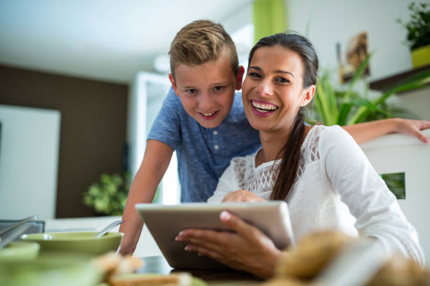 istock Mother and son using digital tablet in the living room 652605762