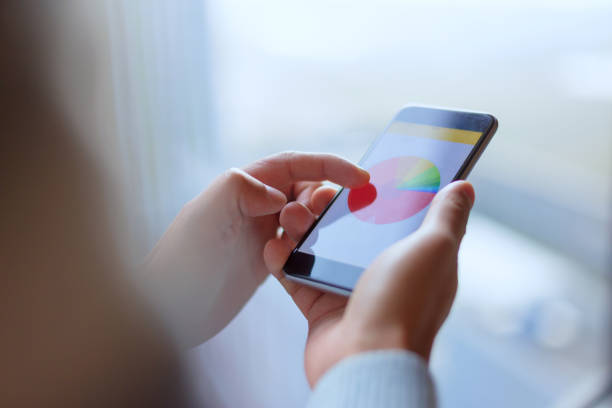 istock mobile phone with stock market 652609672