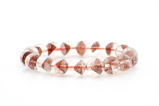 Natural rare Pyramid - shaped mineral inside crystal Quartz beads in bracelet on white background