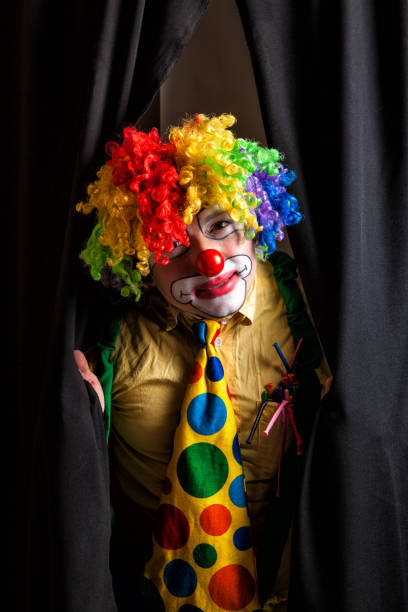 Clown with stage curtains stock photo