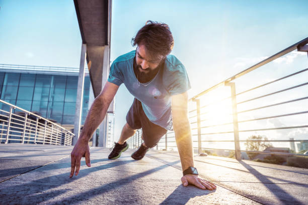 istock bearded sportsman man doing arm push-ups outdoors at sunset 652632416