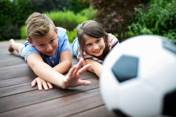 istock Kids playing with football on jetty 652632820