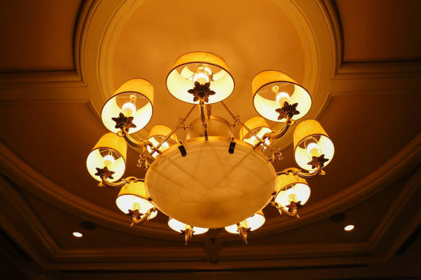istock Yellow lamps with brass structure on ceiling in ballroom 652633082