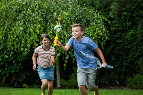 istock Kids playing with bubbles in the park 652635294