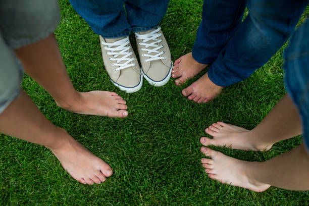istock Family standing on grass in park 652636288