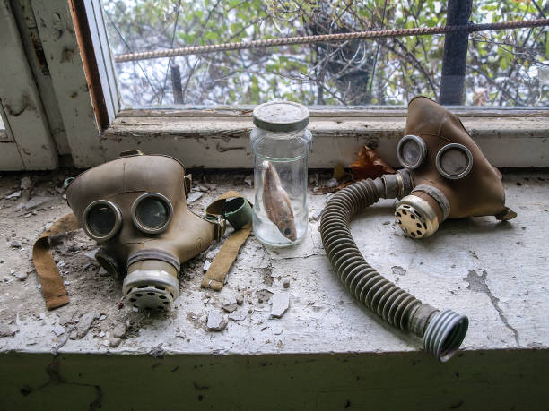 Pripyat in the Chernobyl Exclusion Zone, Ukraine, 2016 Gas masks lying on a window board in the ghost town Pripyat in the Chernobyl Exclusion Zone which was established after the nuclear disaster in 1986 pripyat city photos stock pictures, royalty-free photos & images