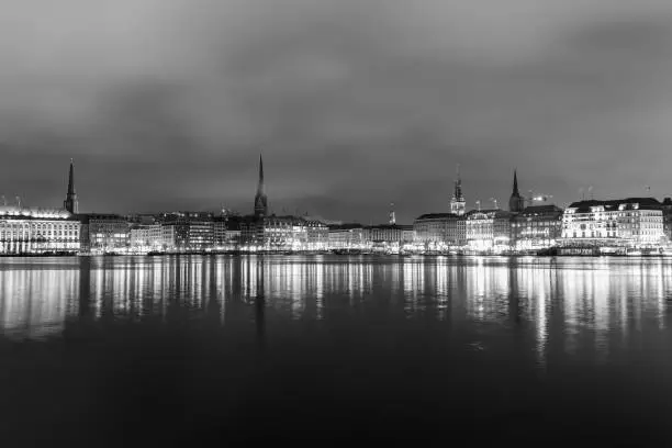 Panoramic View of the Binnenalster in Hamburg Downtown at night in black and white.
