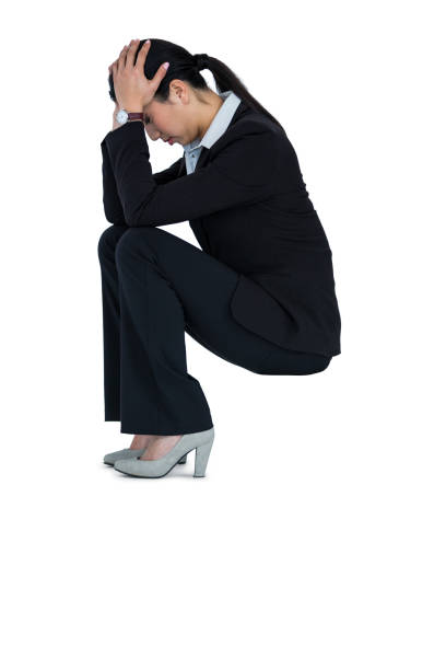 istock Depressed businesswoman sitting on steps with hand on head 652647164