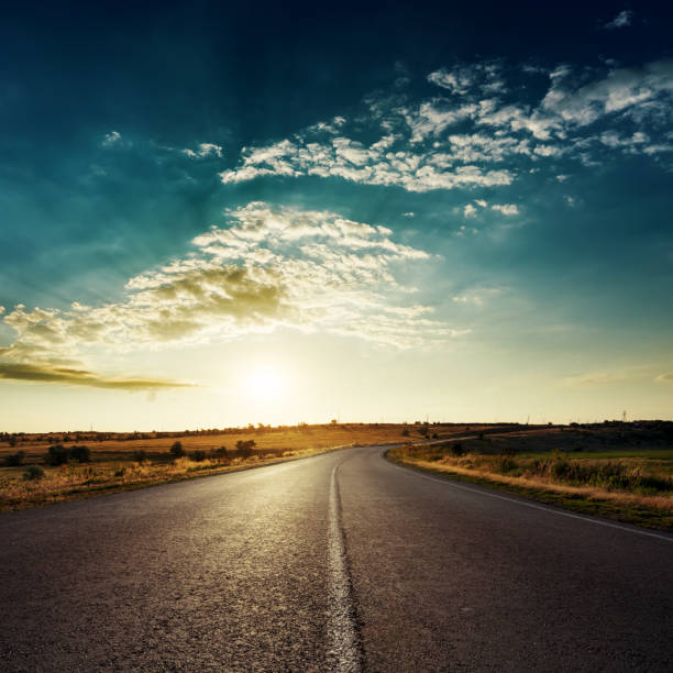 istock low sun in dramatic clouds over asphalt road, sunset time 652648156