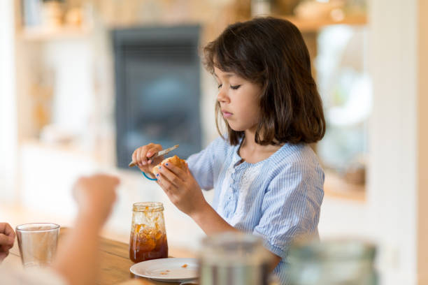 istock Girl putting marmalade on the bread 652650662
